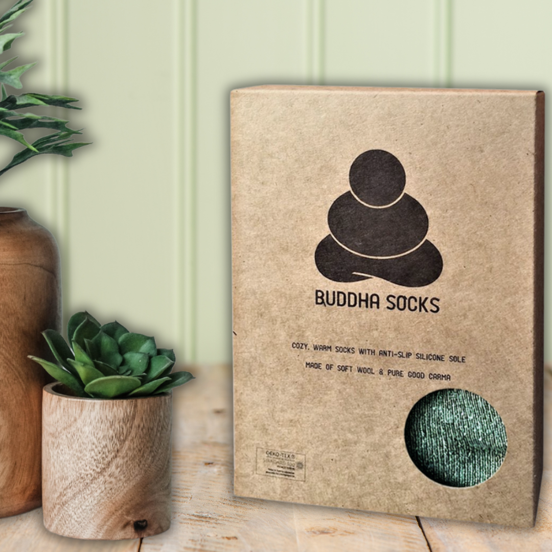 Buddha Socks for men in brown box in table with plants