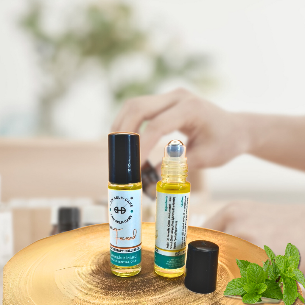 Two small aromatherapy oil rollerball bottles on wooden surface. Things to take someone in hospital