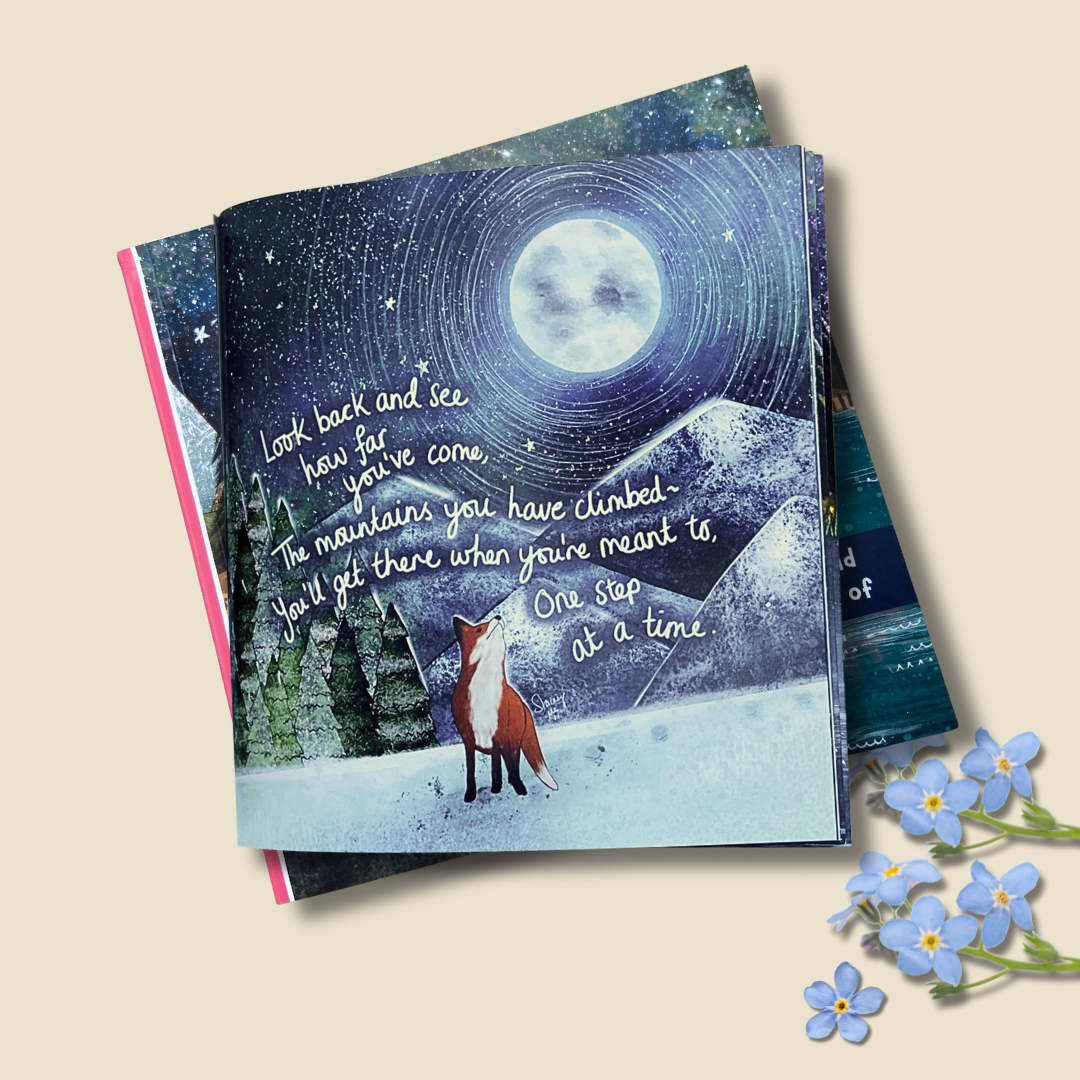 Inside of hug in a book with fox illustration and motivational quote on a night sky background, surrounded by forget-me-not flowers.
