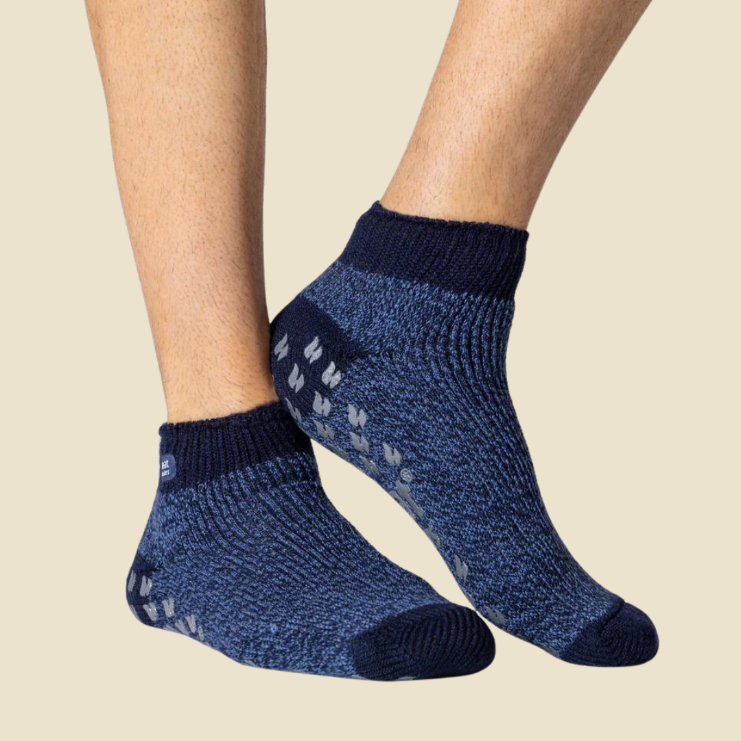 Navy non slip socks for men in blue worn by a person on a beige background