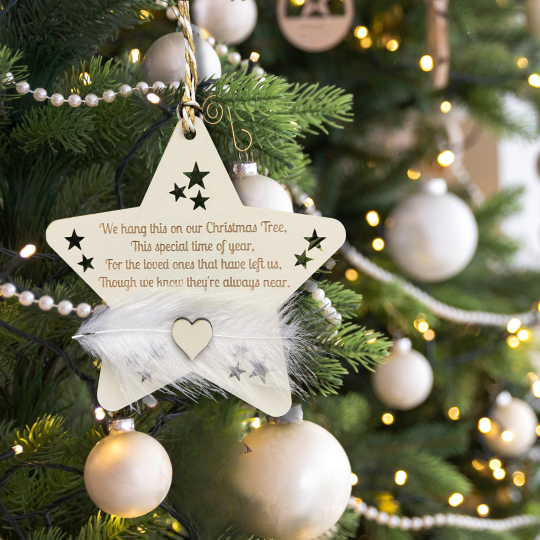 Star-shaped Christmas ornament with feather as a christmas. gift for someone grieving