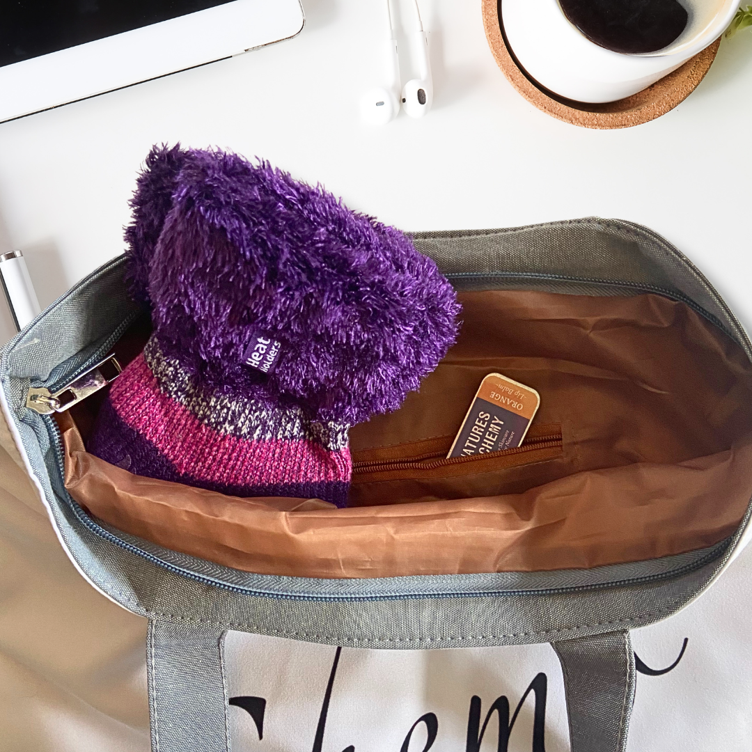 Inside of chemo tote bag on table with cosy socks and lip balm