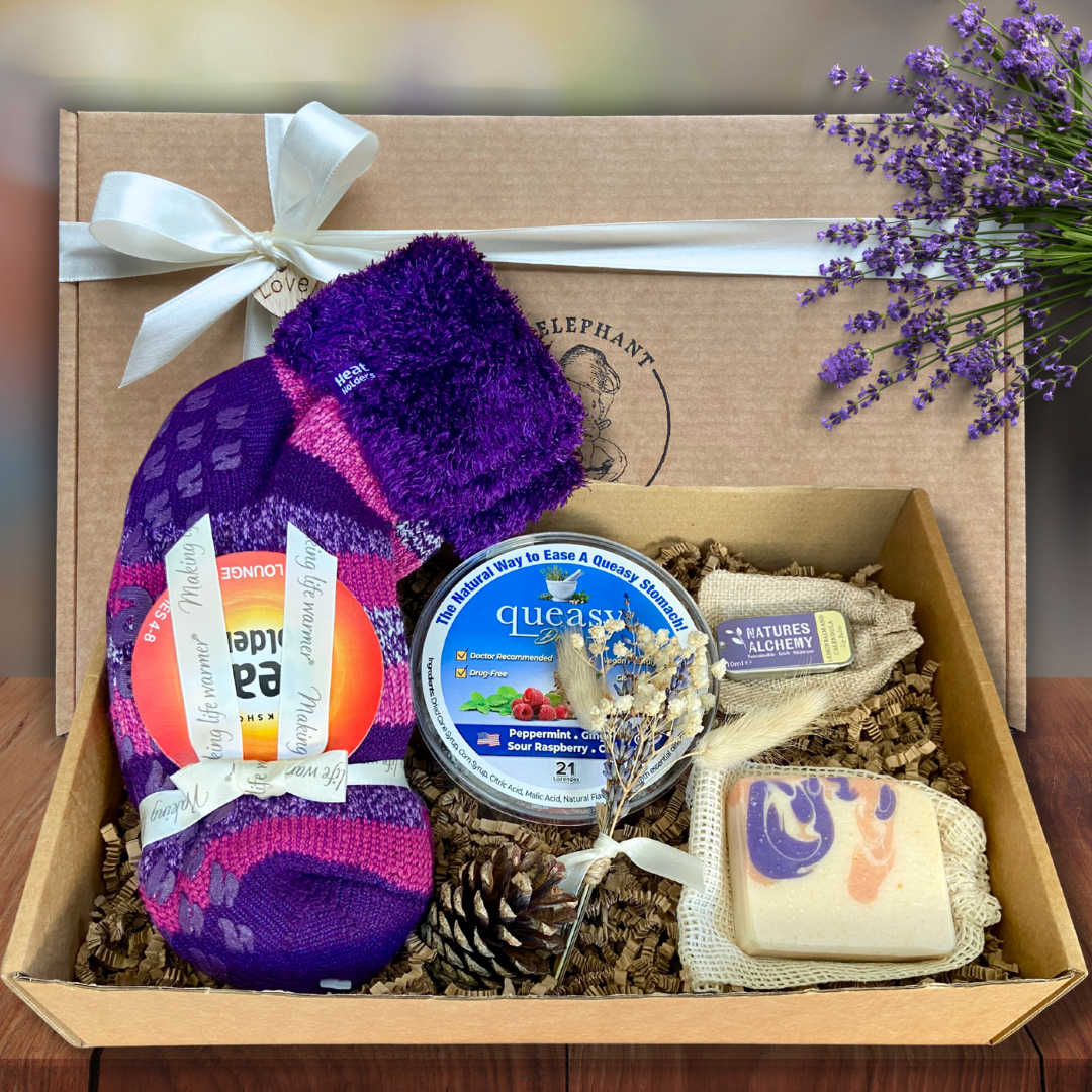 Chemo Care Package For Her on a wooden table. Socks, soaps and lip balms included.