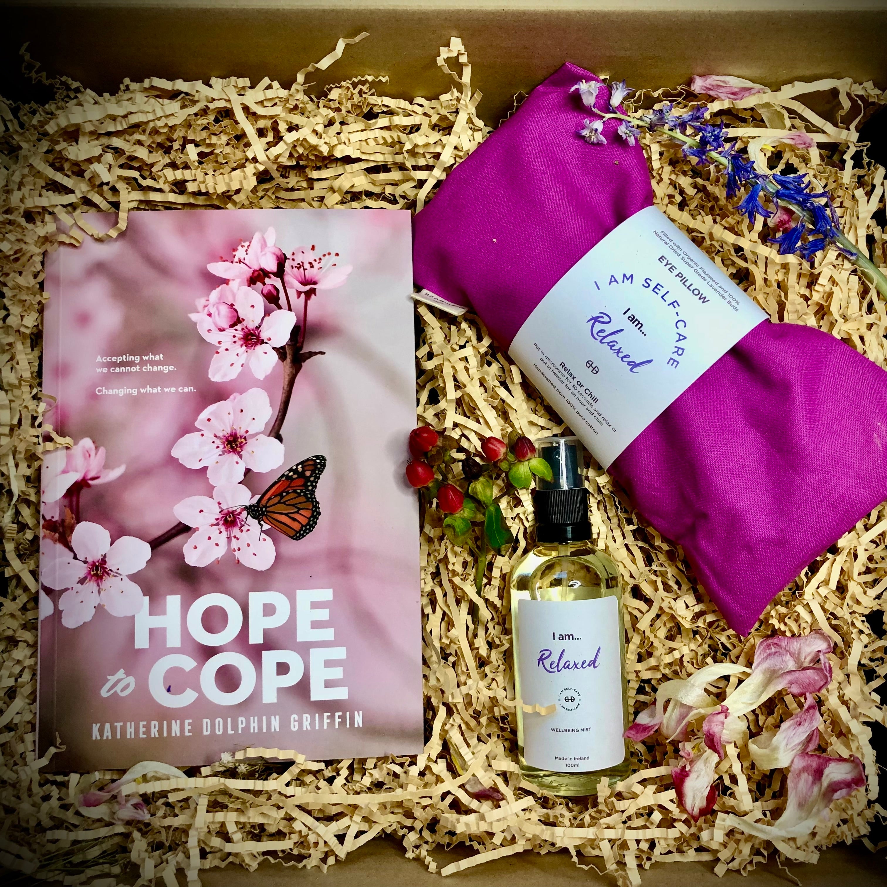 Gift set with 'Hope to Cope' book, eye pillow, and bottle labeled 'I am Relaxed' in a gift box.