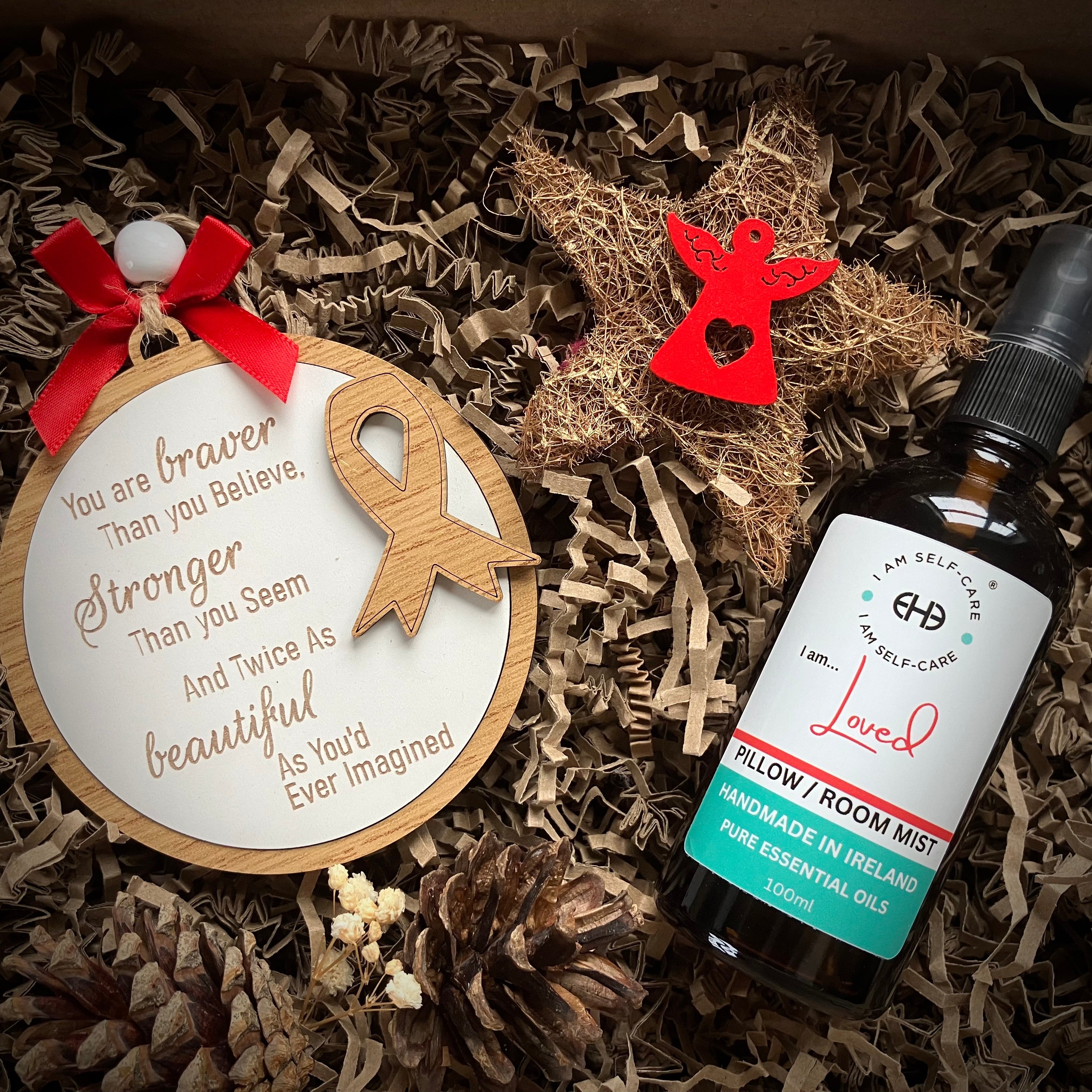 Cancer strong quote on decoration and bottle of essential oil mist in a gift box
