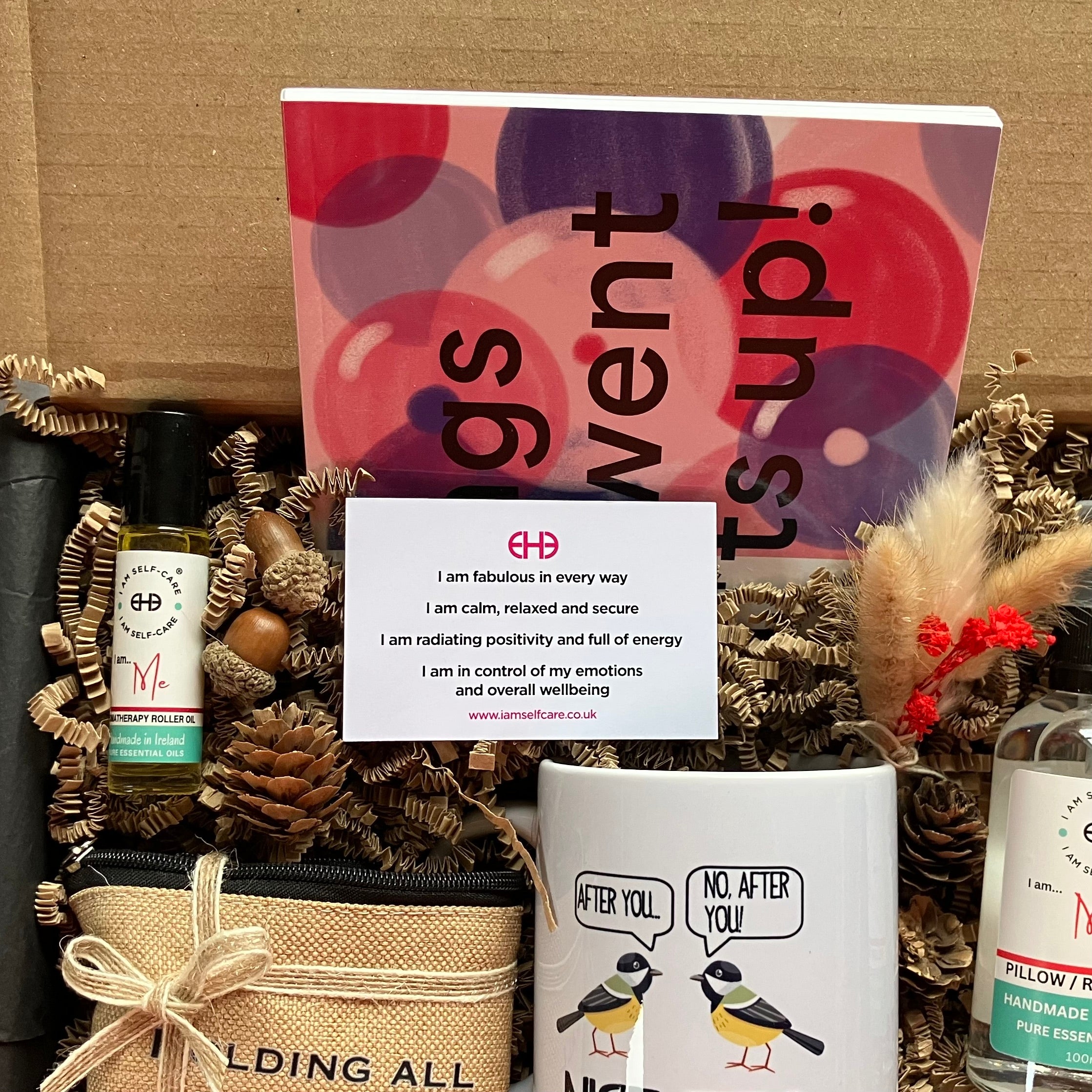Cancer care package with an affirmation card, mug, rollerball and book.