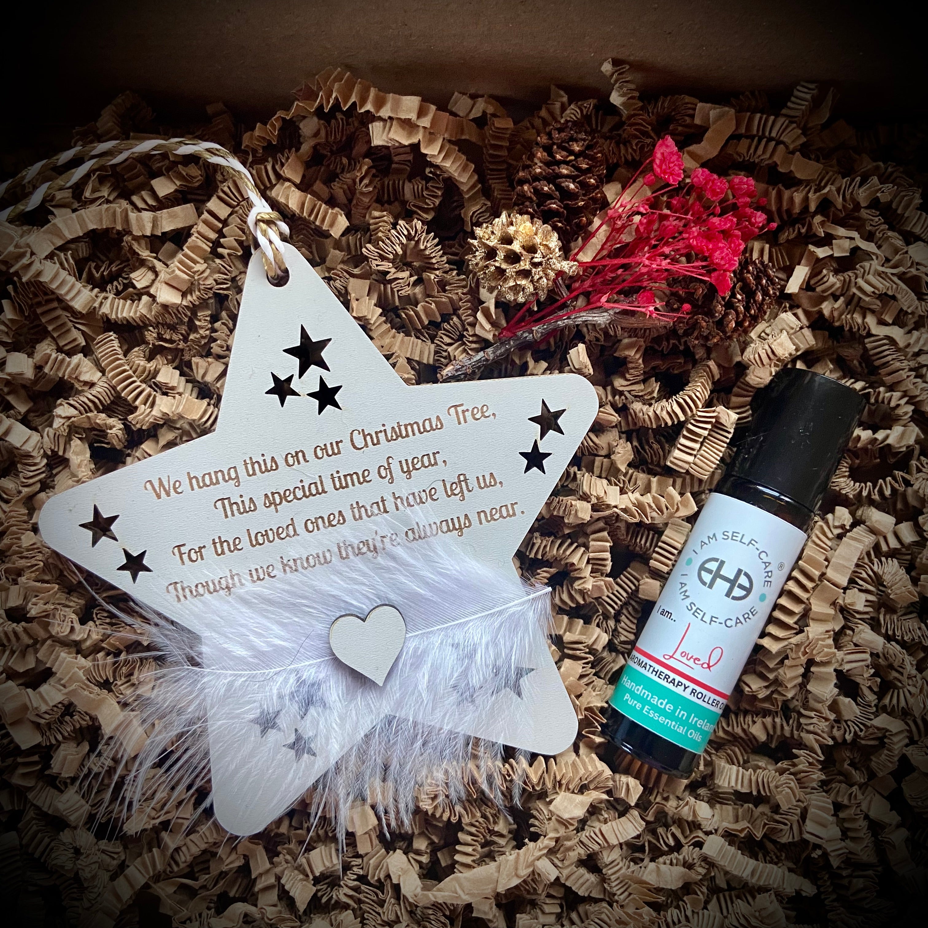 Star-shaped ornament in a care package with a aromatherapy roller oil bottle.