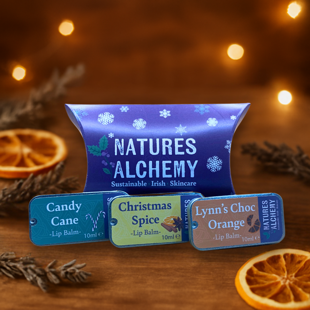 Christmas Lip Balm Gift Set on a table with dried orange slices and lavender sprigs