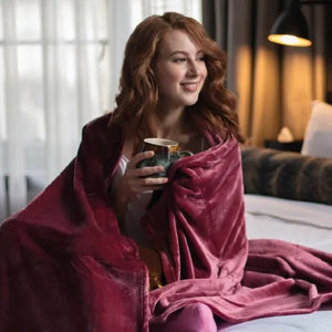Girl wrapped in thermal blanket in cherry pink