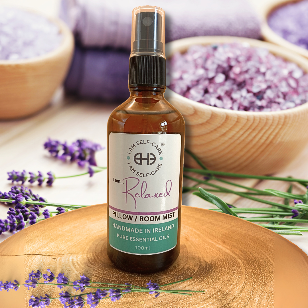 Bottle of 'Relaxed' pillow/room mist with lavender flowers on a wooden surface