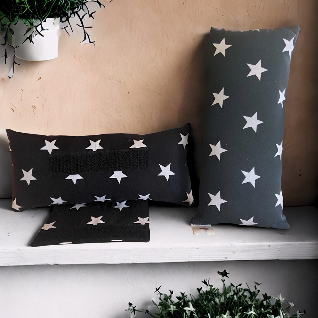 Star-patterned  seat belt  pillow on a wooden surface with a neutral background